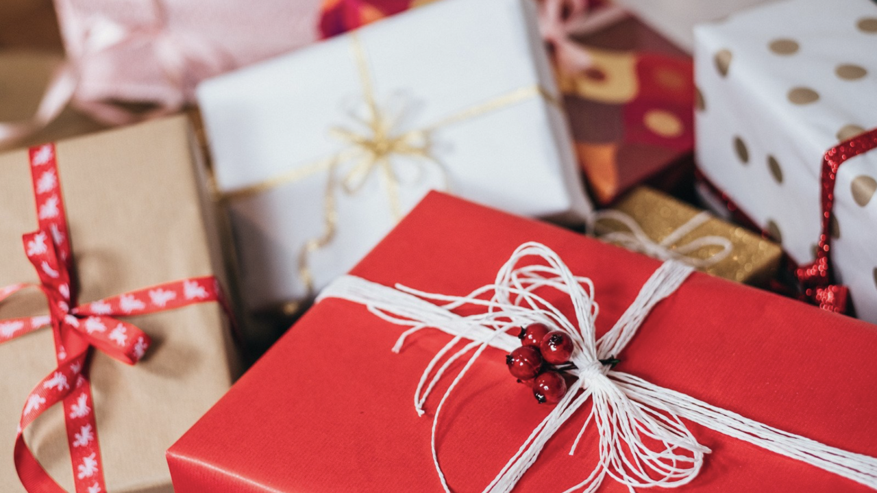 A pile of gifts wrapped in various papers and ribbons.