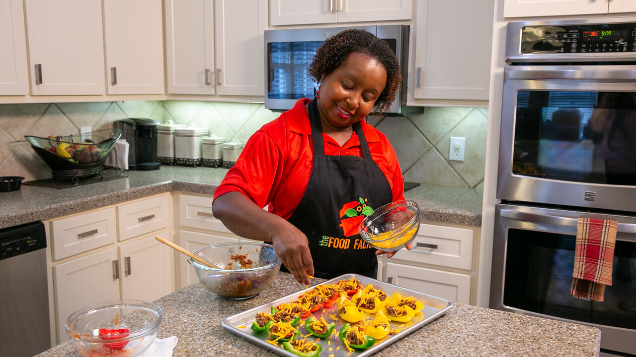 A woman prepares Bell Pepper Nachos in a kitchen.