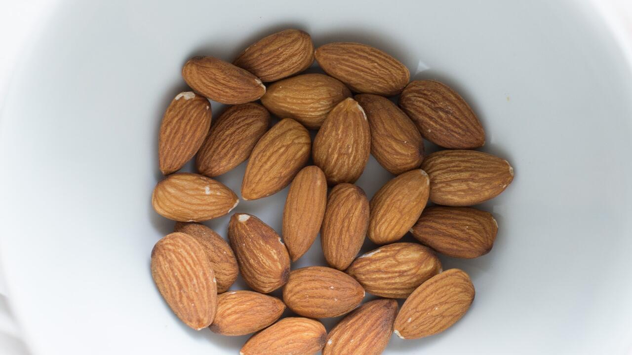 Almonds in a white bowl.