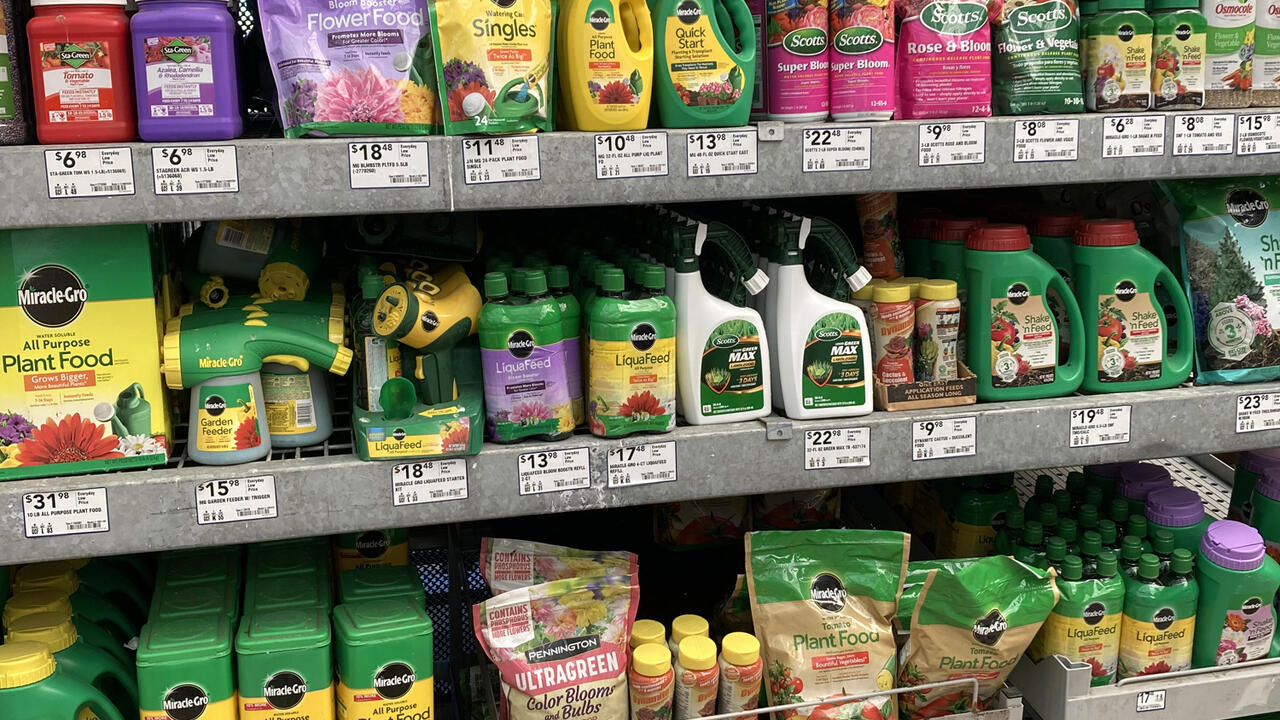 Bottles and bags fill a row of shelves in a store.