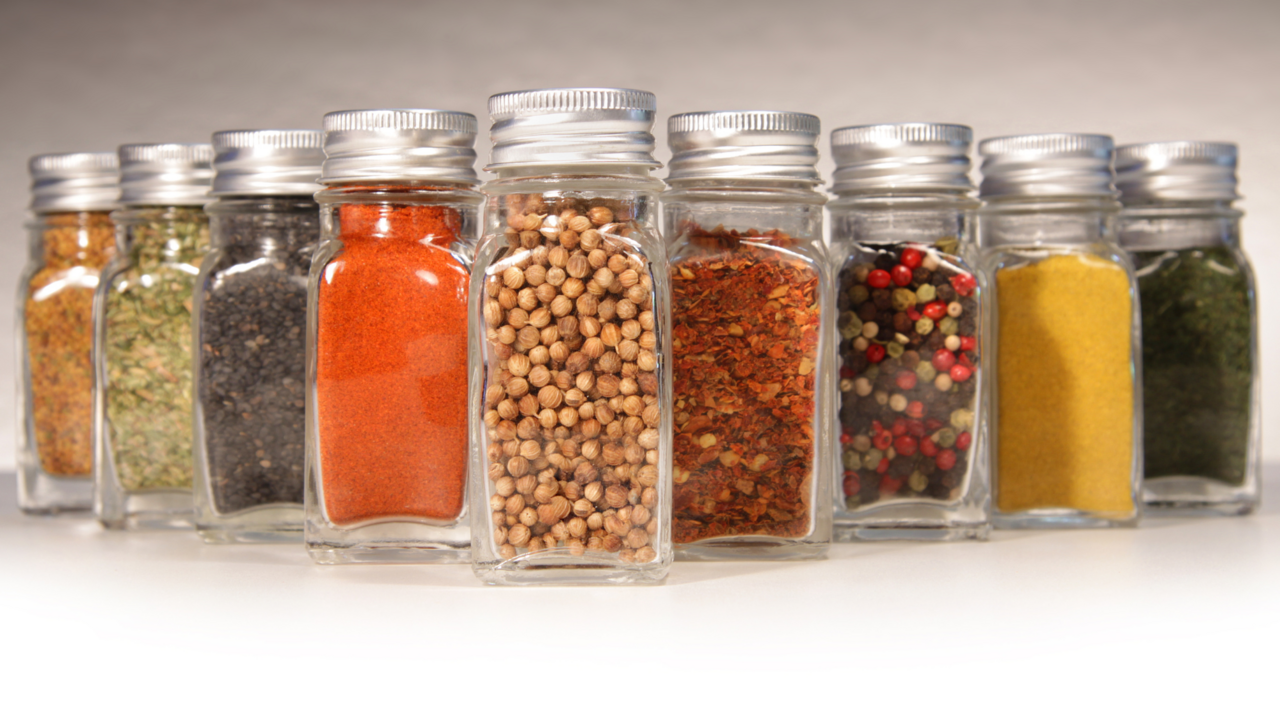 Jars of spices lined up in a V formation.