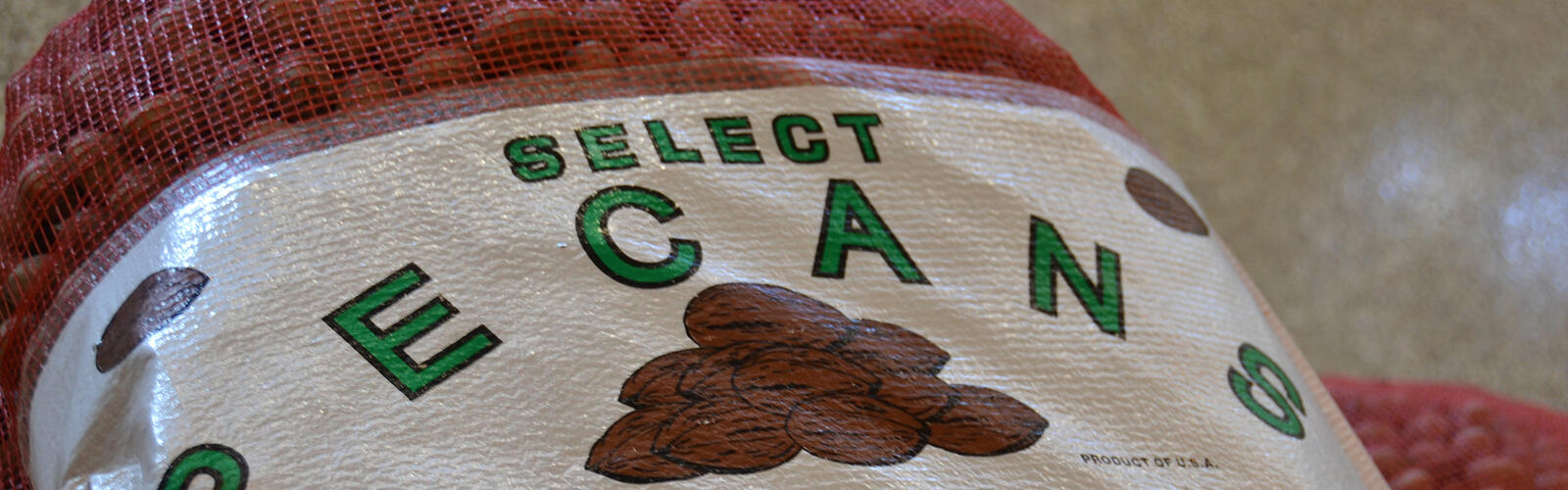 A closeup of a label on a 50-pound bag of in-shell pecans.
