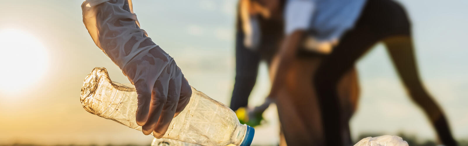 Person picking up trash.