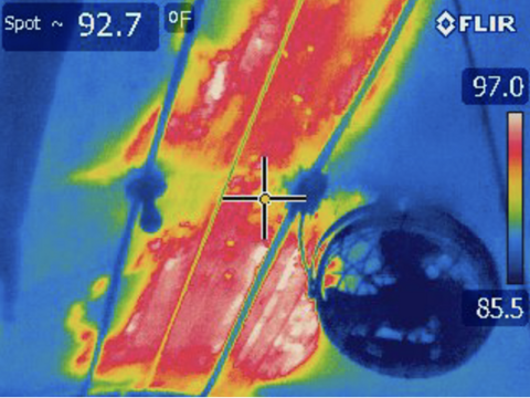 Thermal camera screen shows concentrated red and yellow in the center of the image.