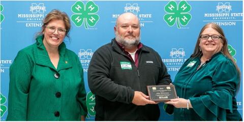 Dr. Mariah Morgan and Connie Darden present Jake Dickerson with an award