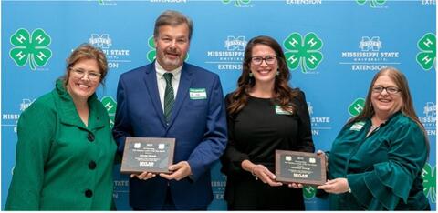 Connie Darden and Dr. Mariah Morgan present David Grady and Monica Grady with an award