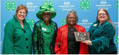 Ella McPherson is presented with an award