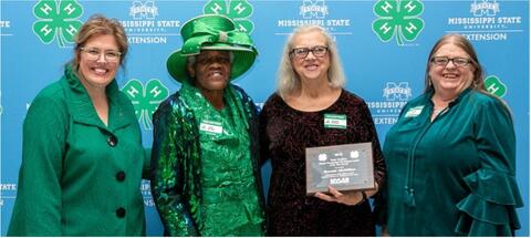 Renetta McMillan is presented with an award