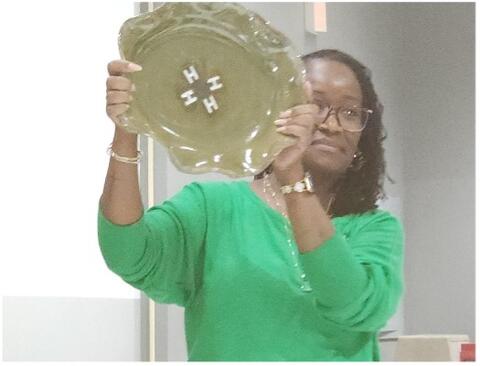 A woman holds up a platter