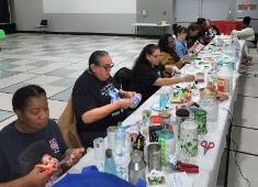A group of people sit at a long table