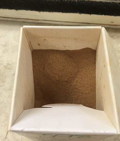 Soil sample container filled with soil.