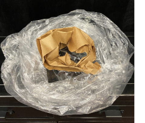 A clear plastic bag is placed around a collar of brown kraft paper.