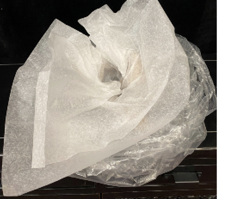 Waxed paper is added in a circular fashion within the collar of brown kraft paper and clear plastic bag.