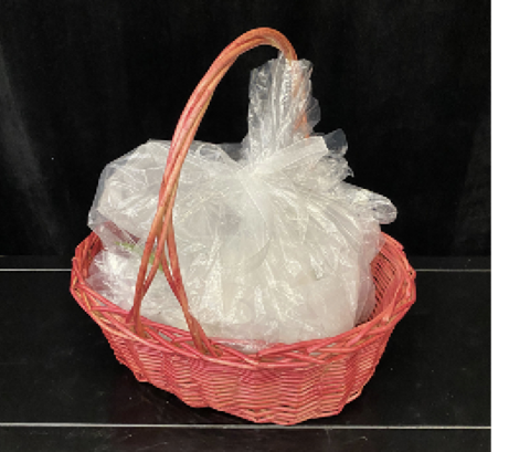 A bagged bouquet is placed in a red wicker basket.