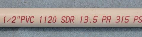 PVC pipe with specifications printed on it: 1/2 inch, 1120, SDR, 13.5, PR, 315, PS.