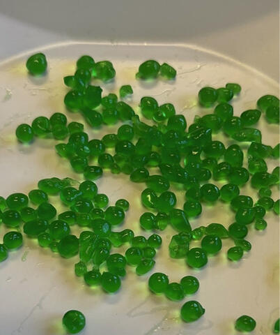 Closeup of gel bead clusters on a pan.