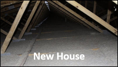 Wood beams with blown cellulose filled to top of bottom chord of truss in a new house.