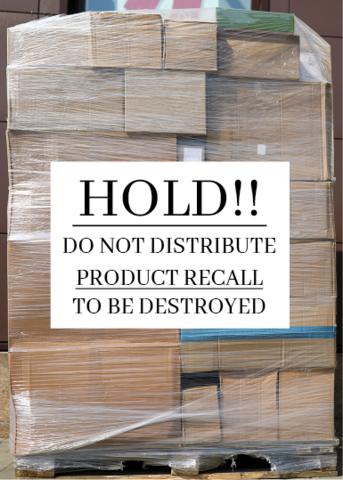 A stack of cardboard boxes on a pallet. All of the boxes are shrinkwrapped together, and a sign attached to the stack reads "Hold!! Do not distribute. Product recall. To be destroyed.