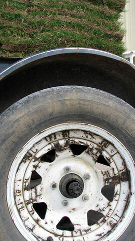 A poorly maintained wheel with a worn tire.