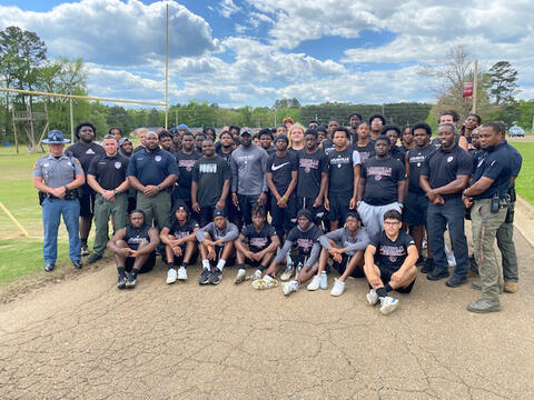 A group of people, including young men and police officers.