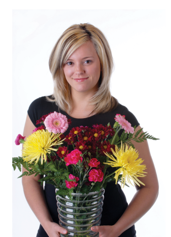 A person holding a vase of flowers.