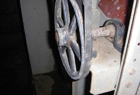 A closeup of a belt-drive fan.