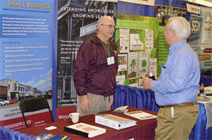 Two men in discussion at a business development workshop.