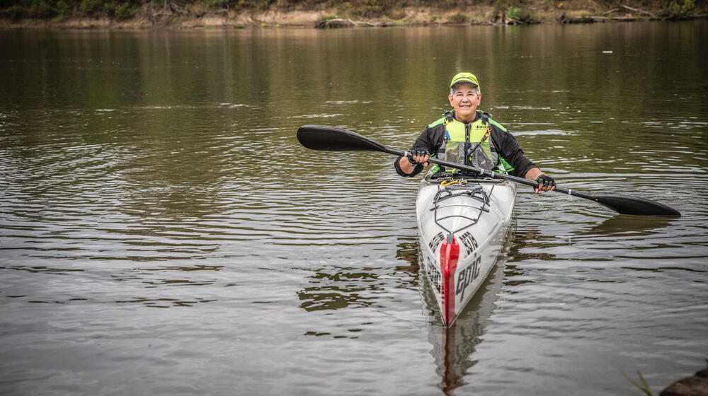 A woman kayaking on the water.