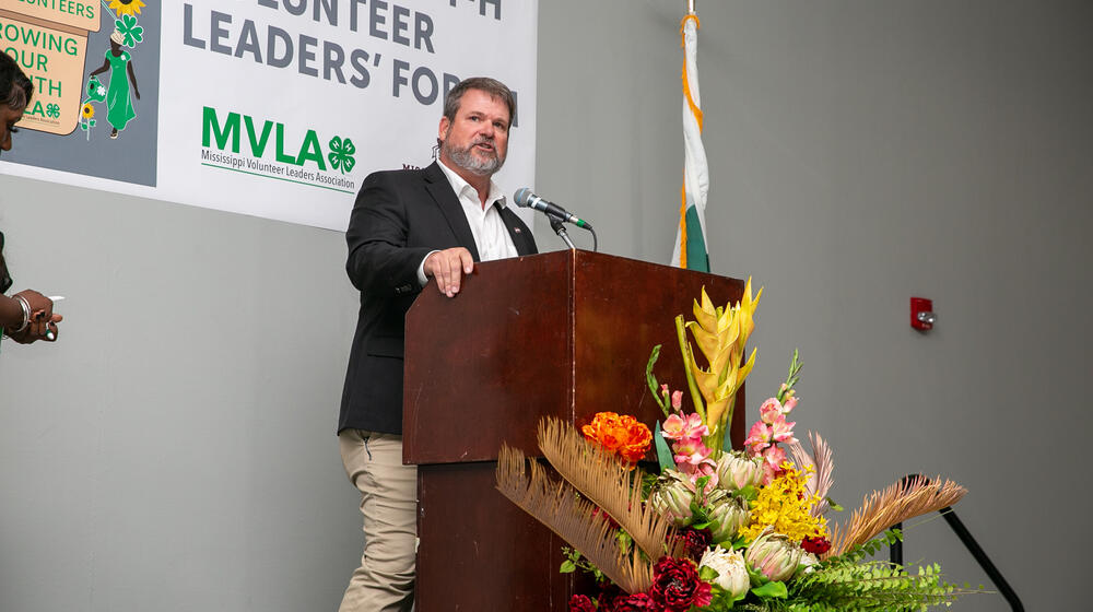 A man standing at a podium with a microphone.