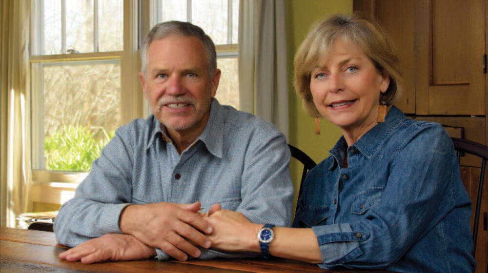 A man and woman sit at a table.