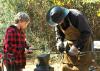 Fourth-generation blacksmith Chuck Averett helps Morgan Alexander make an arrowhead at the Piney Woods Heritage Festival held Nov. 16 and 17 at Mississippi State University's Crosby Arboretum. (MSU Ag Communications/Susan Collins-Smith)