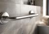 Closeup of stainless steel safety grab bar in a bathroom.