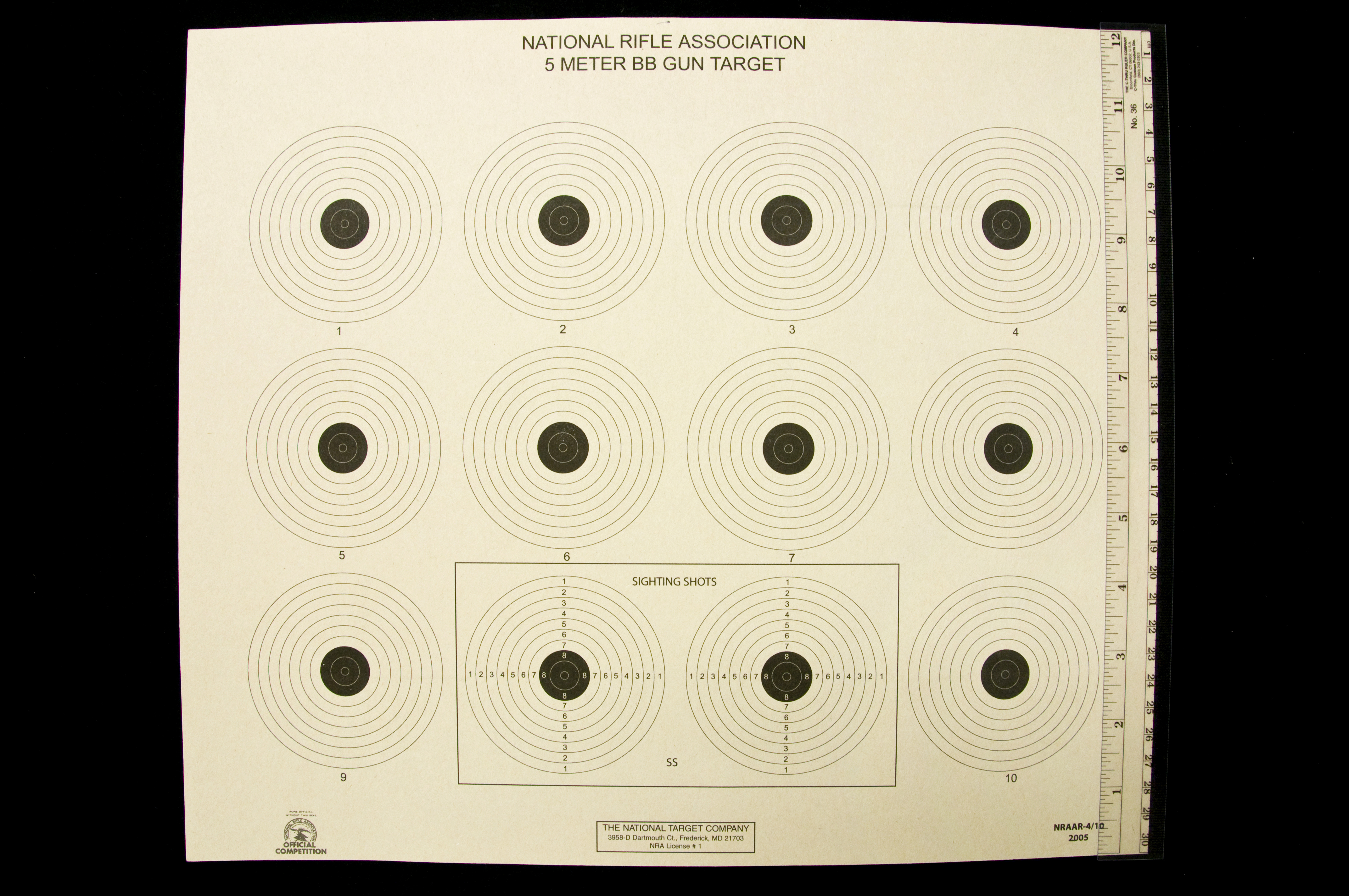National Rifle Association 5 Meter BB Gun Target with 12 targets and two of them enclosed in an rectangle with SS labeled on them, all of which have seven larger white outer circles and three smaller inner black circles.